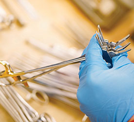 Technician examining forceps