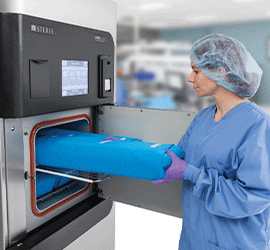 Technician Loading Instrument Tray into Sterilizer