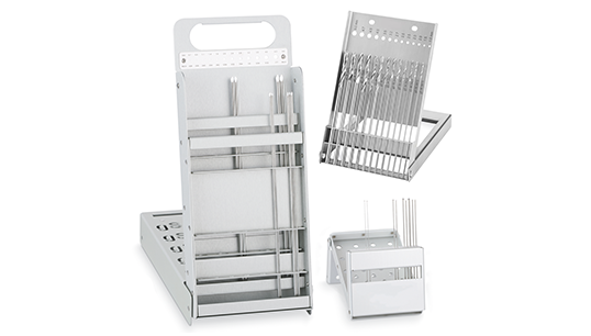 Sterilization racks holding wires, pins, and twist drill bits.